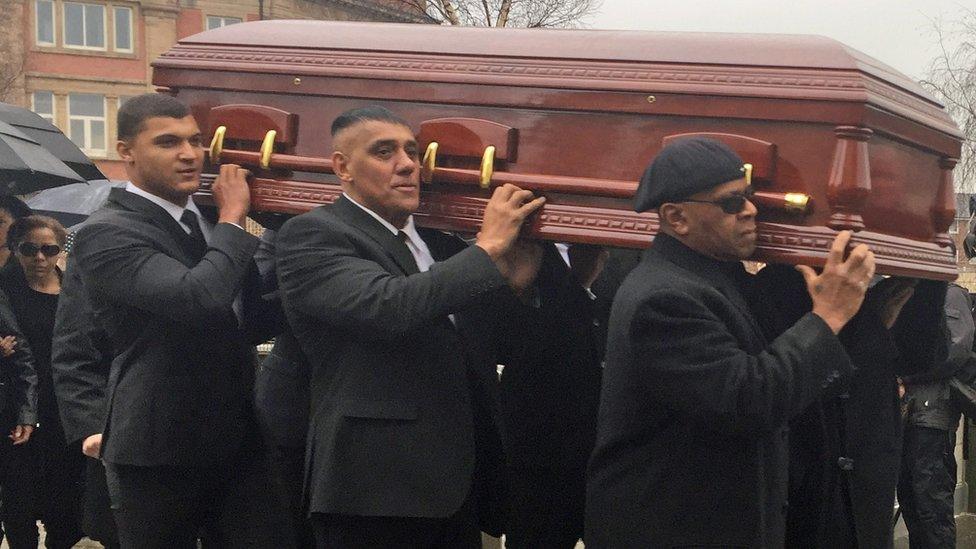 Eddy Amoo's coffin is carried in