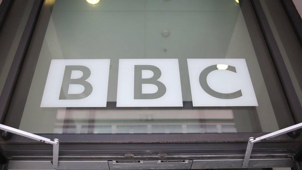 Window above a door showing the BBC logo