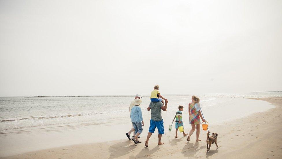 A family walk on a beach