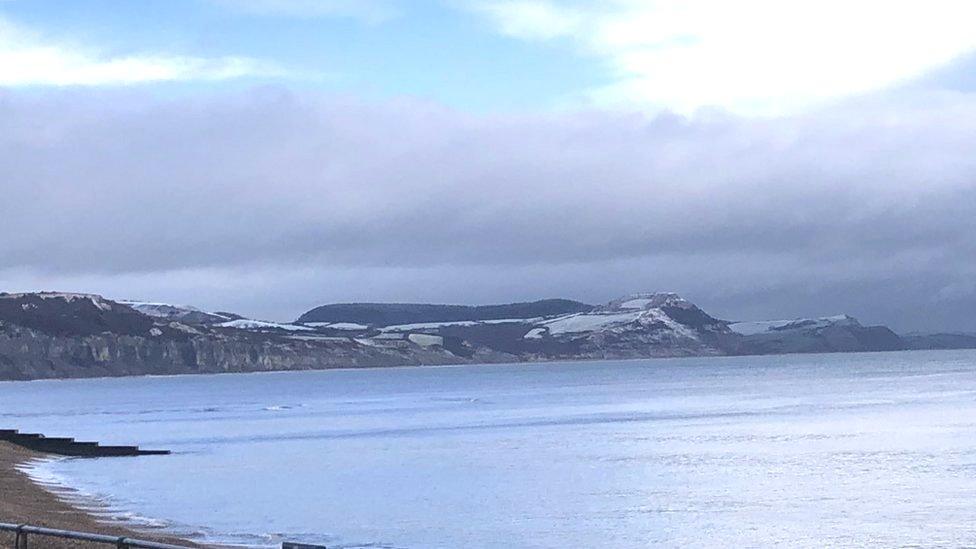 View of Golden Cap coastal cliffs covered in a dusting of snow