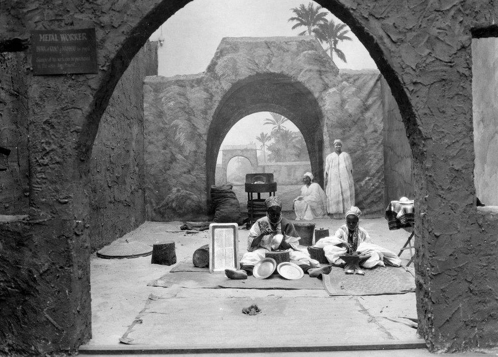 Black and white image of metal workers at work in West Africa pavilion