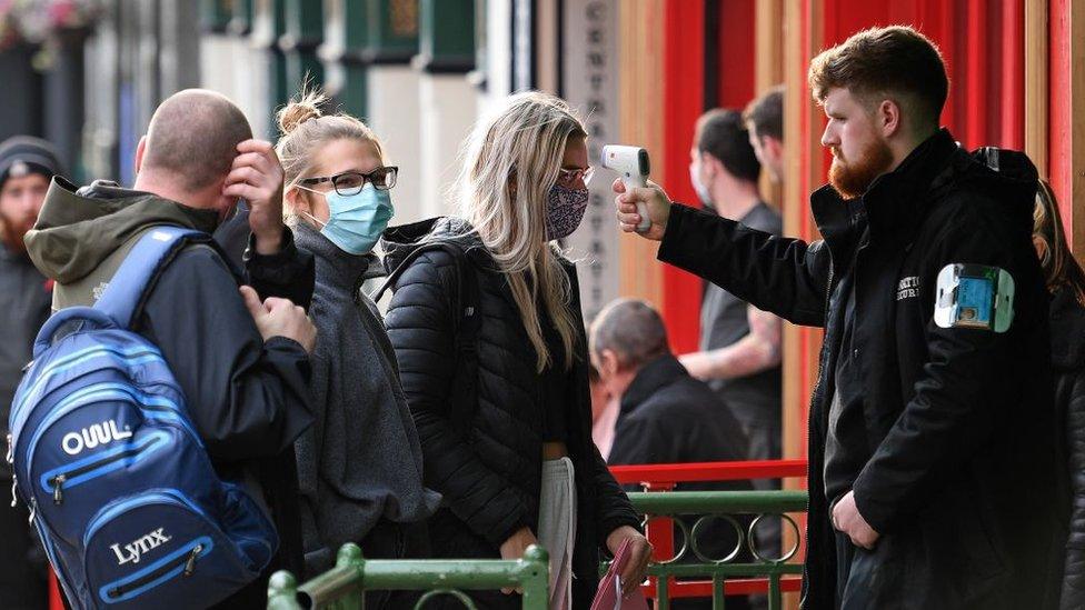 People being temperature scanned outside bar in Liverpool