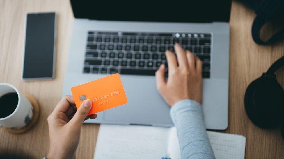 A photo of a woman paying for something