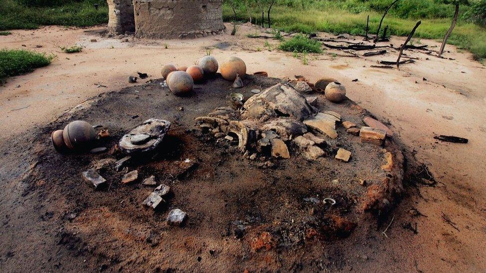 The smouldering remains of the village of Chero Kasi are seen here September 8, 2004, a day after it was set ablaze by Janjaweed militiamen in the violence plagued Darfur region of Sudan