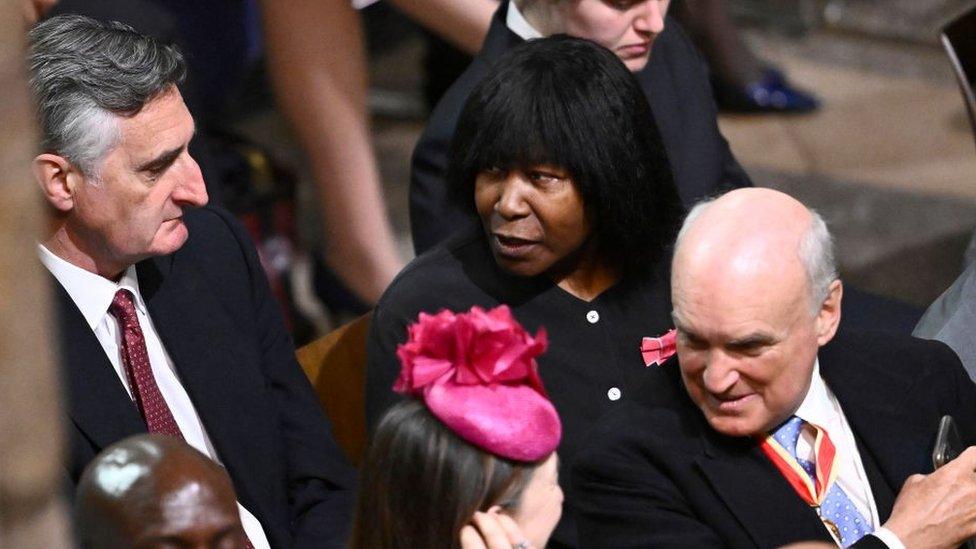 Singer Joan Armatrading (centre) sitting in Westminster Abbey