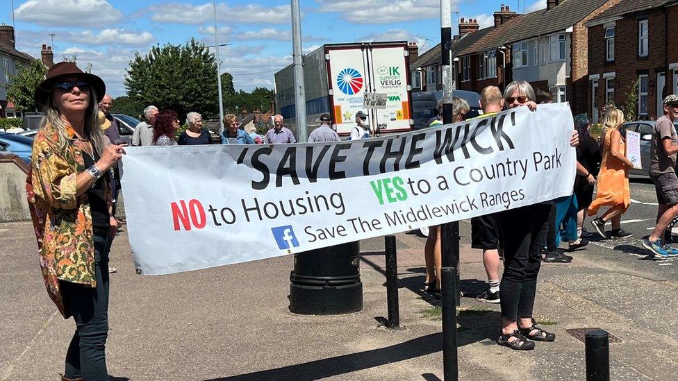 Protesters holding a "Save the Wick" banner during a protest in Colchester