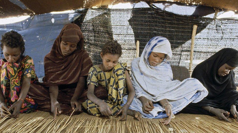 UN photo of girls making a carpet