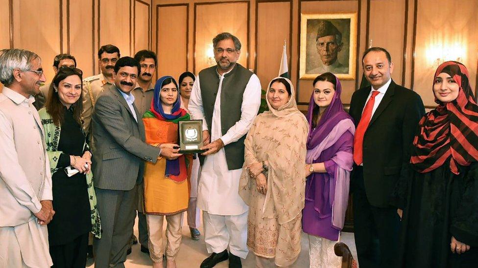 Malala receiving a shield from Pakistani Prime Minister Shahid Khaqan Abbasi on her visit to Islamabad