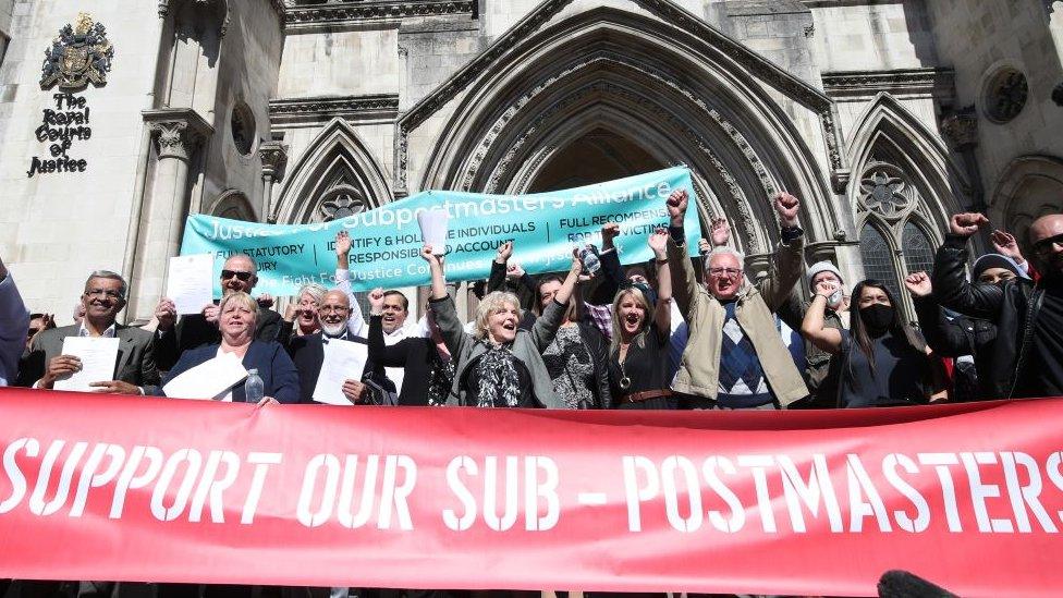 People celebrate outside the Royal Court of Justice.