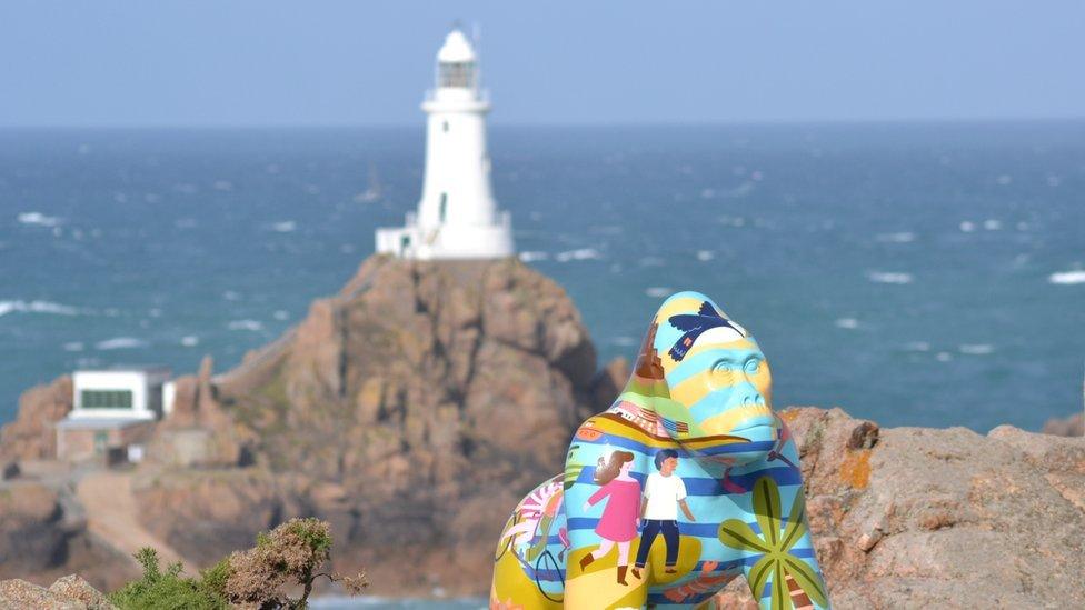 Gorilla statue in front of lighthouse