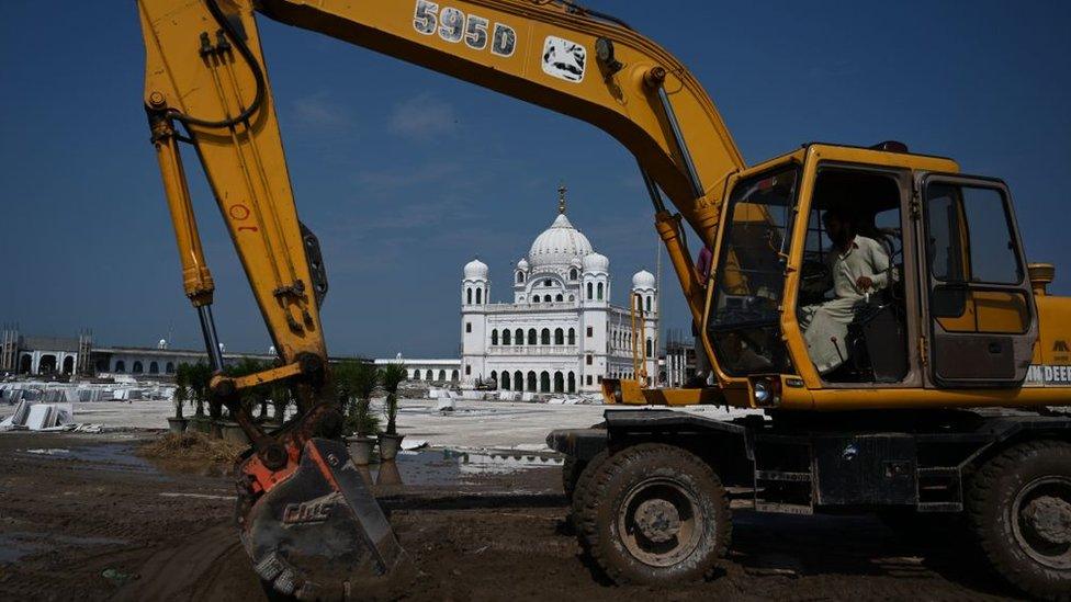 In this picture taken on September 16, 2019 a worker uses an excavator to level ground at the Sikh religious site Gurdwara Darbar Sahib, in the Pakistani town of Kartarpur near the Indian border.