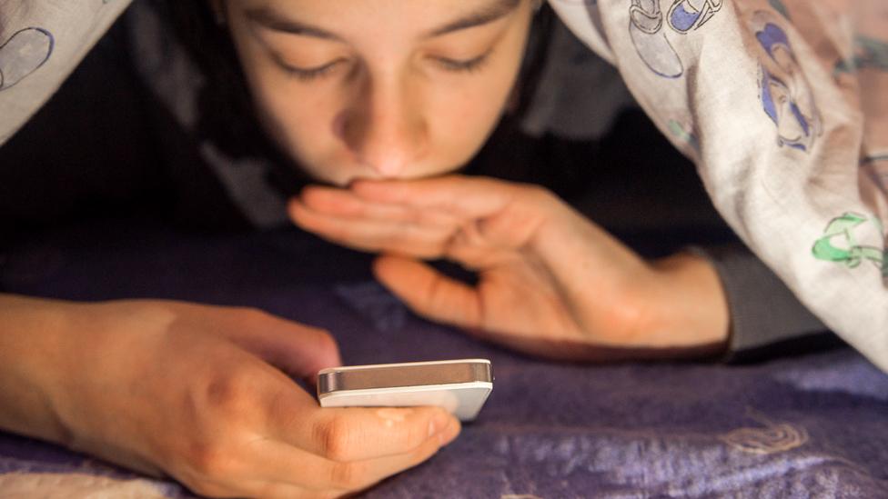 Teenager using a smartphone