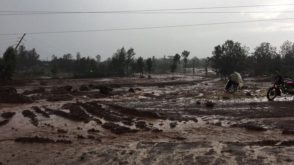 People roam in land devastated by the dam burst in Solai, Kenya on 10 May 2018