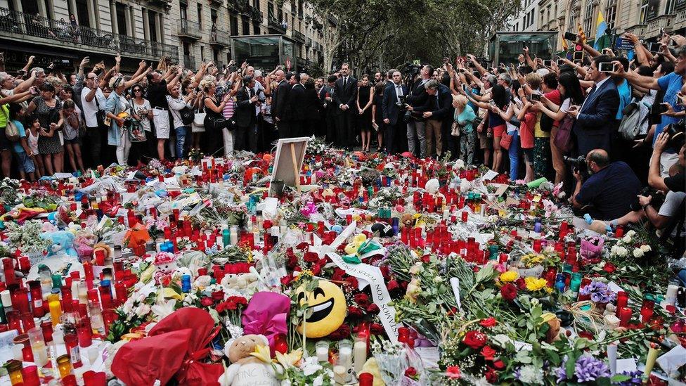 People light candles, leave flowers and notes for the victims who lost their lives in the terror attacks