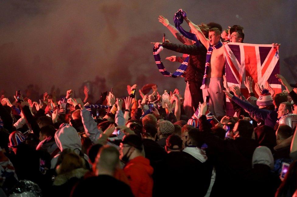 Rangers fans celebrate in George Square, Glasgow after the club wins the Scottish Premiership title. 7 March 2021.