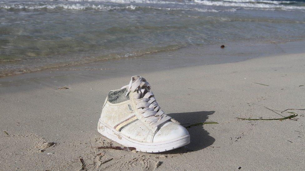 A shoe washed up on the shore are pictured near a route frequented by migrants trying to cross the Mediterranean, near the coastal town of Zuwara, west of Tripoli, Libya, June 4, 2016.