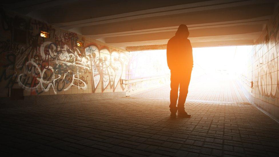 Silhouette of a man in a tunnel