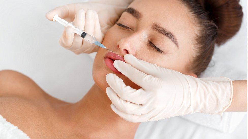 Woman having a lip filler