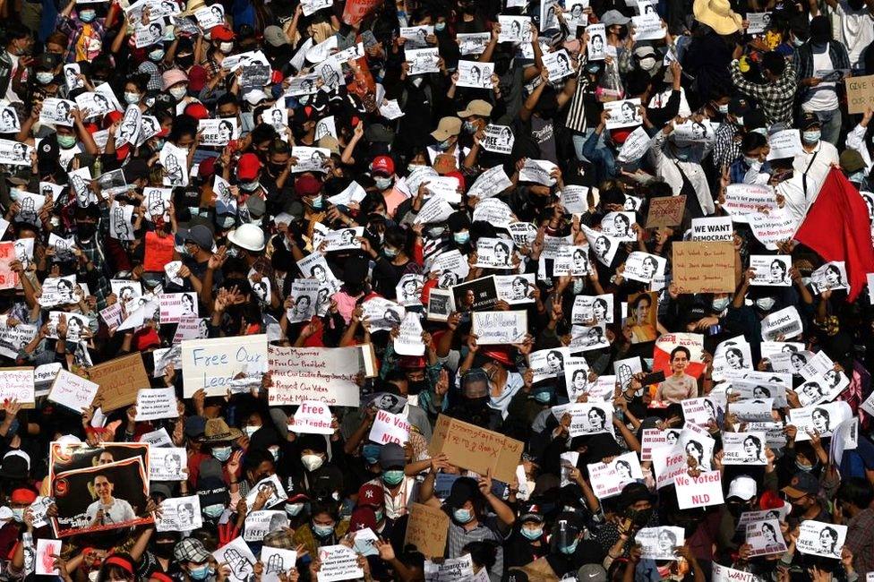 Protesters hold signs demanding the release of detained Myanmar leader Aung San Suu Kyi during a demonstration against the military coup in Yangon on February 9, 2021.