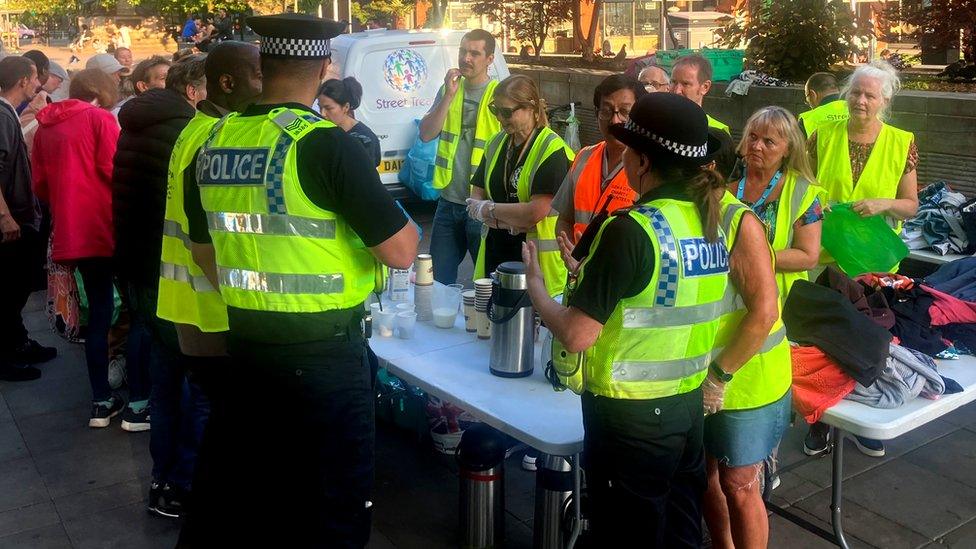 Police officers peaking to Street Treats volunteers