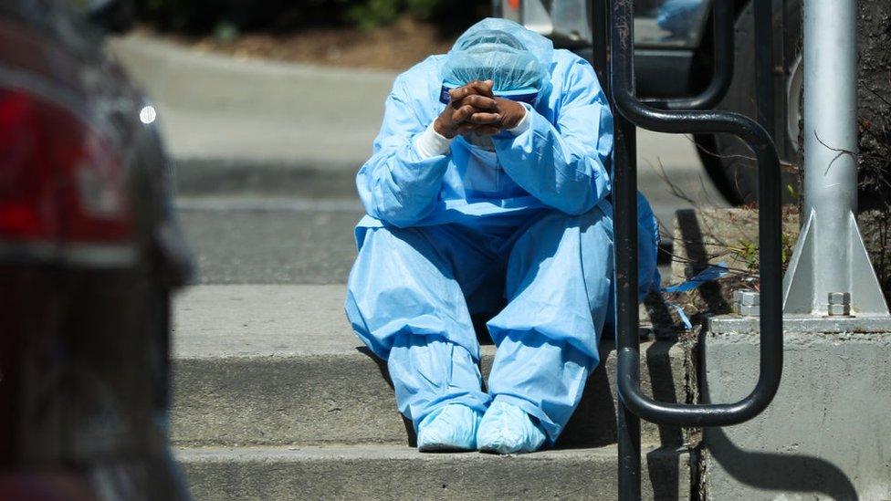 A tired healthcare worker is seen by the Brooklyn Hospital Center in New York, United States on April 1, 2020