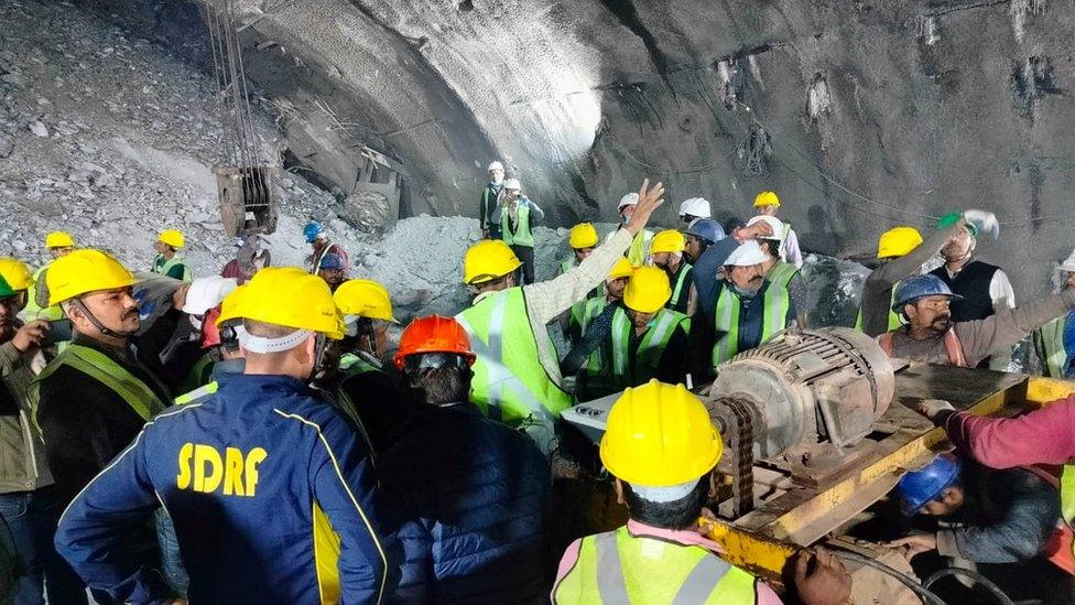 Rescue workers gather at the site after a tunnel collapsed in the Uttarkashi district