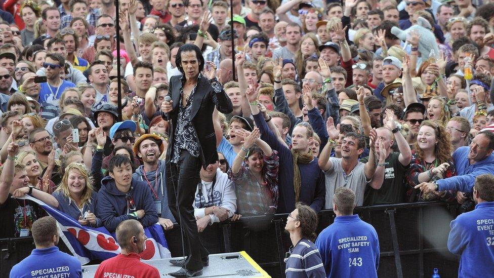 Nick Cave performing for fans at Glastonbury Festival in 2013