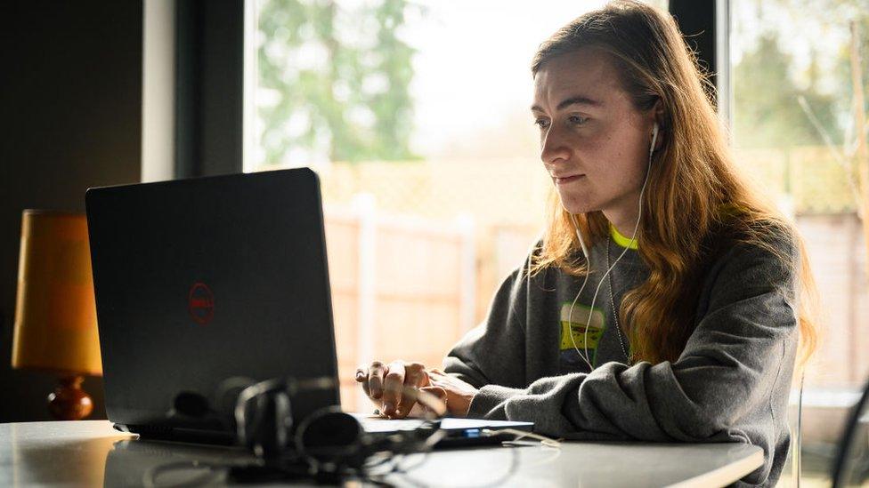 student looking at laptop computer