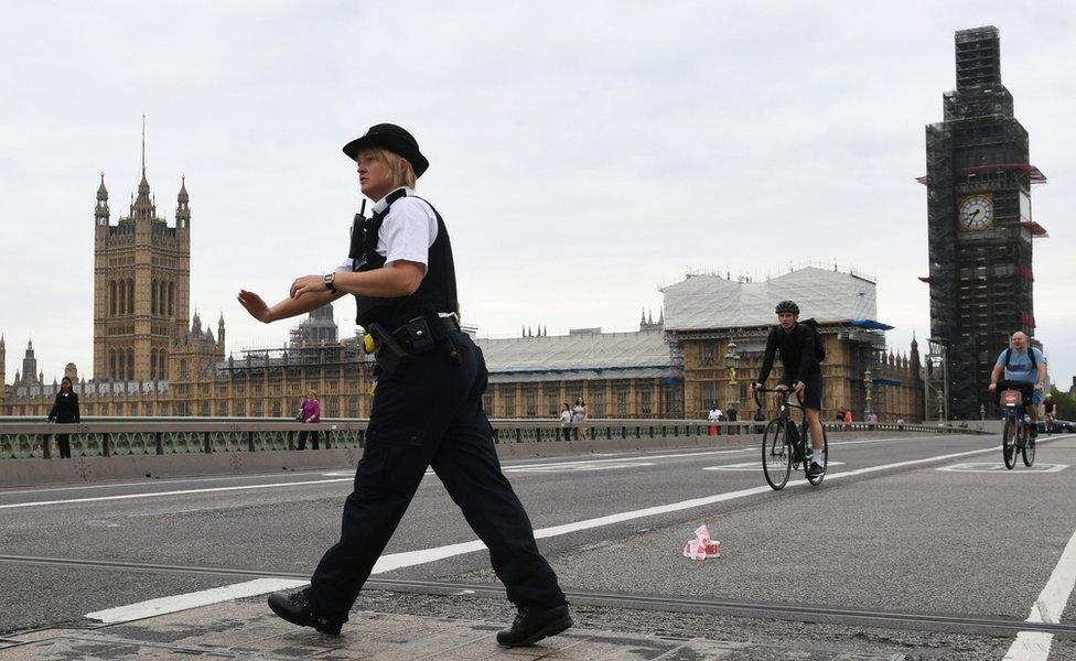 Police on Westminster Bridge, central London, after a car crashed into security barriers outside the Houses of Parliament.