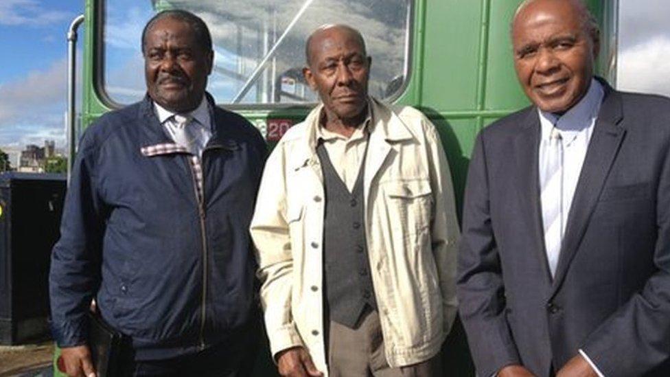 Guy Bailey, Roy Hackett and Paul Stephenson in front of one of the original green buses - modern photo