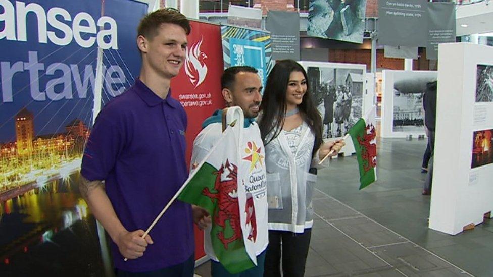 Swansea City footballer Leon Britton poses with the baton