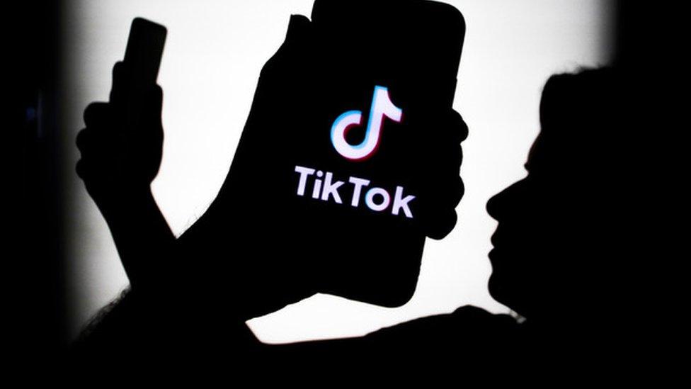 TikTok logo on a phone