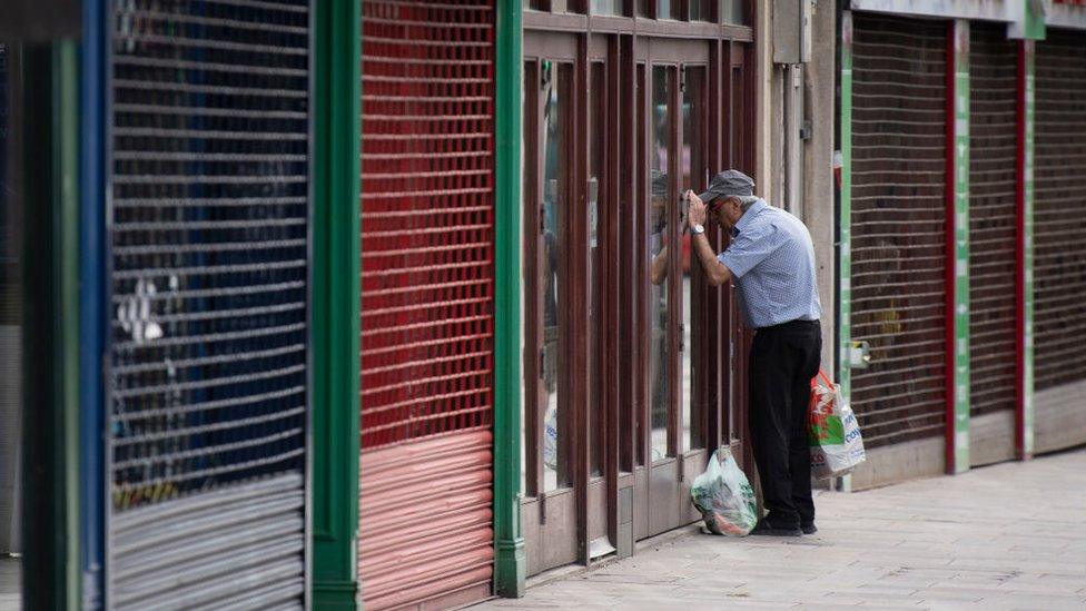 A man looking through a shop window