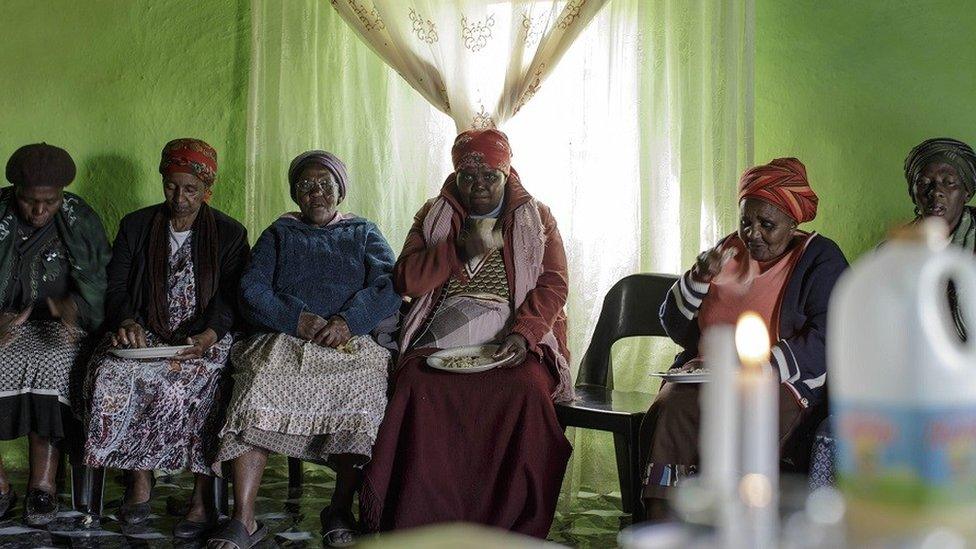 Women sitting for a funeral