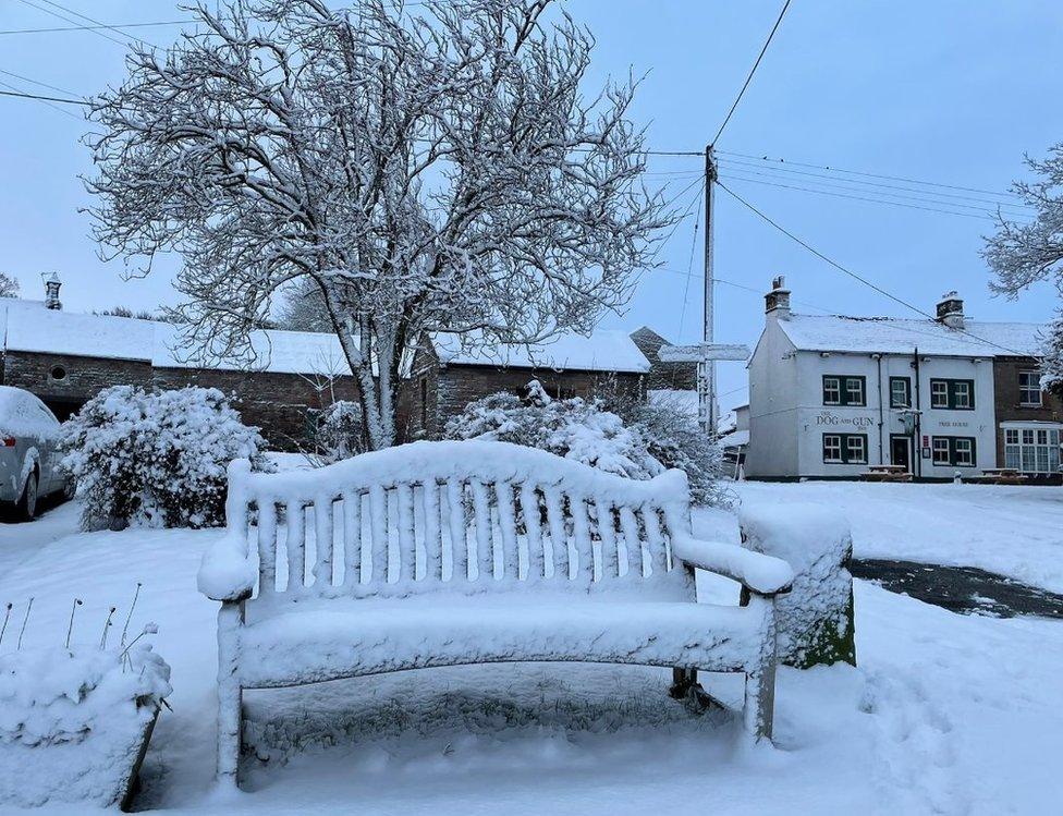 A bench in the snow