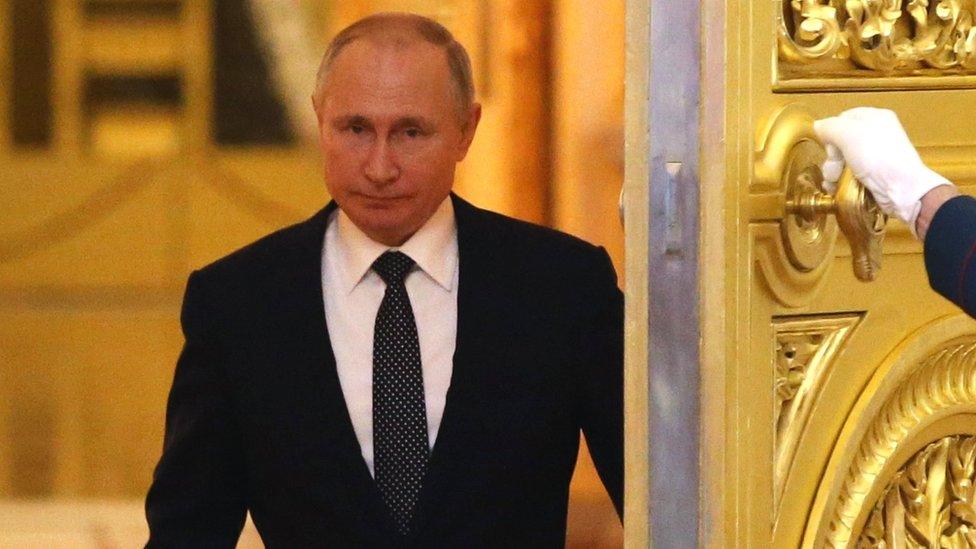 Russian President Vladimir Putin enters the hall during the reception marking the Day of Heroes of the Fatherland at Grand Kremlin Palace in Moscow, 11 December 2019