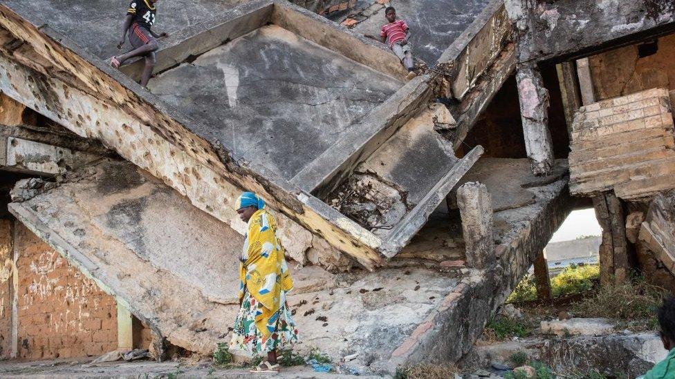 Children play in a derelict building damaged during the civil war in Angola, Kuito - 2019