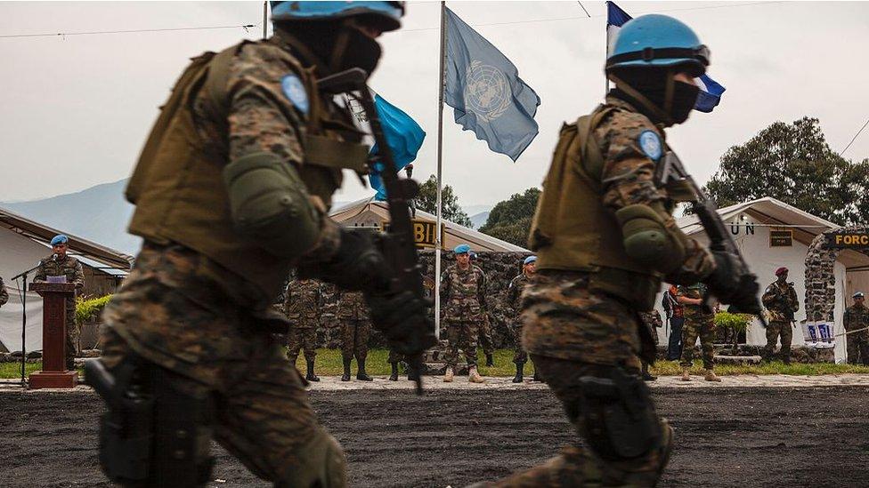 Major General Jean Baillaud (C), deputy head of the UN Mission in the Democratic Republic of Congo (MONUSCO), visits the Guatemalan military base in Sake on July 12, 2016 as members of the Guatemalan Special Forces 'Kaibil', stationed in the Democratic Republic of the Congo as part of the MONUSCO peacekeeping force, take part in a drill