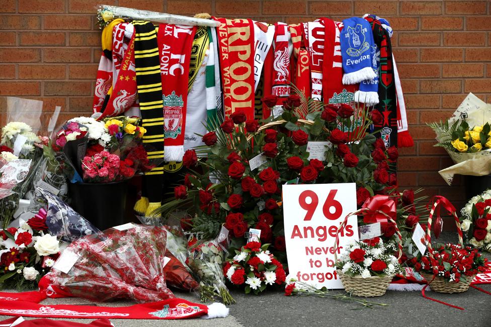 Flowers are placed at the Hillsborough memorial plaque during the Hillsborough 27th Anniversary Memorial Service at Anfield