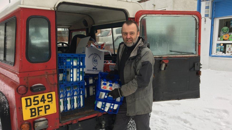 Picture of Gareth Jones delivering milk from his Land Rover