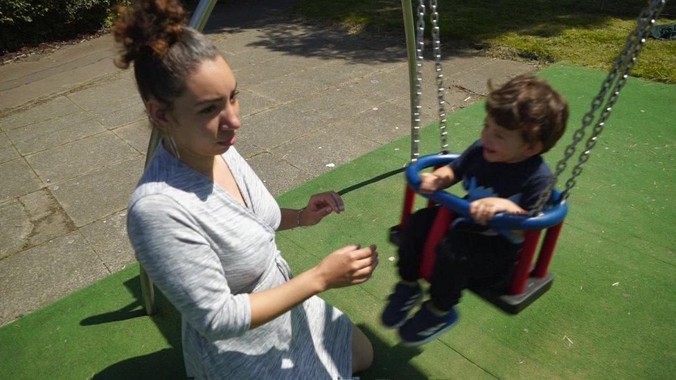 Jade Thomas and child on swing