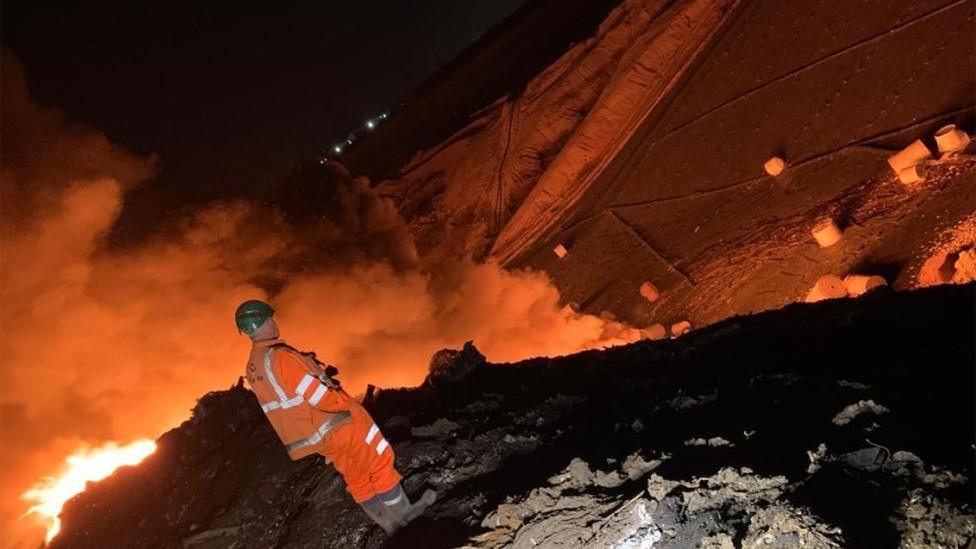 Firefighter at landfill fire