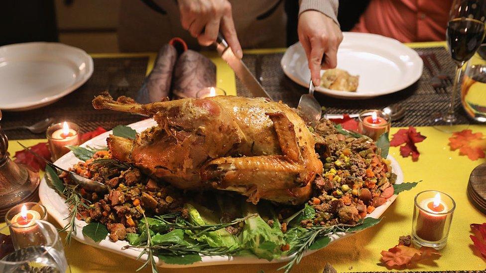 A Guatemalan immigrant carves the Thanksgiving turkey