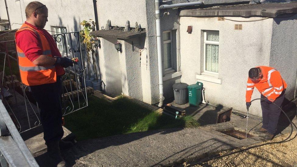 Gareth Hamilton and Steve Tyler clearing a drain