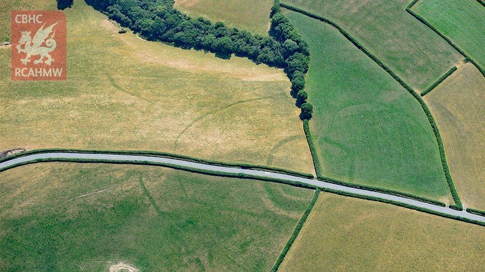 Iron Age farmstead Whitland seen with a modern road running through it