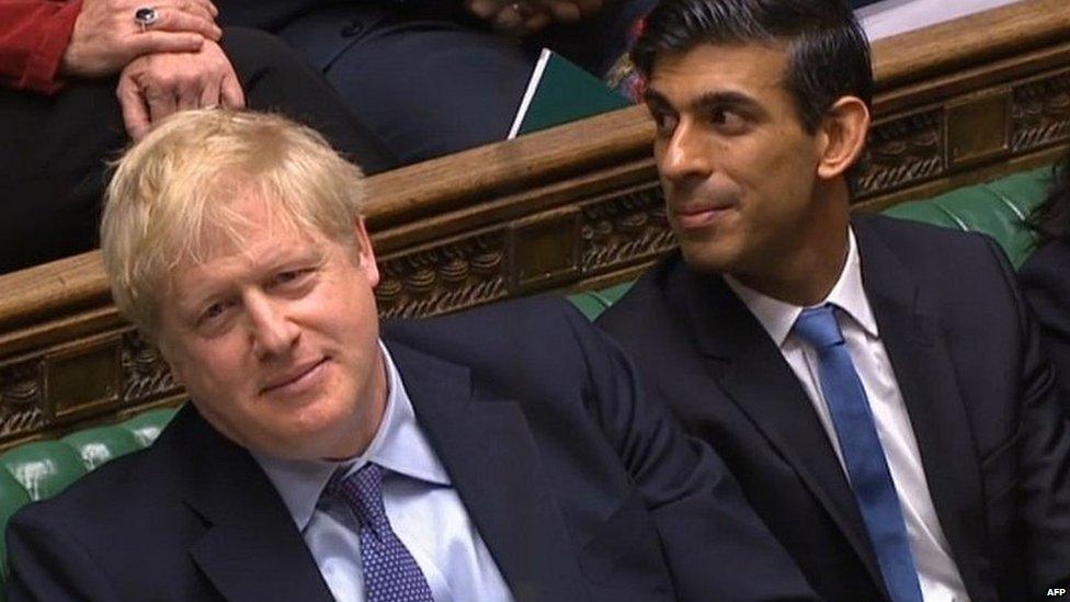 Boris Johnson and Rishi Sunak listening to the ex-chancellor's remarks