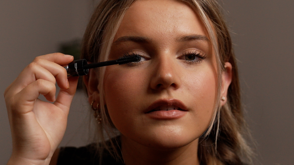 Ruby David putting on mascara