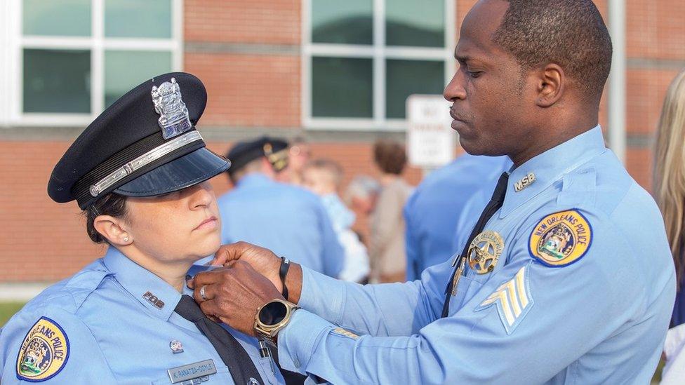 A police officer attaches an EPIC pin to a colleagues lapel