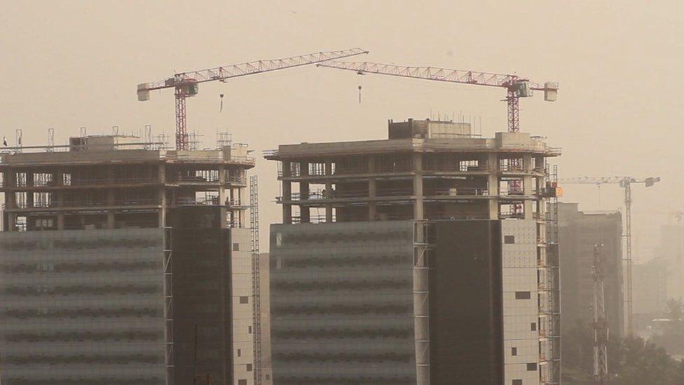 Cranes above buildings