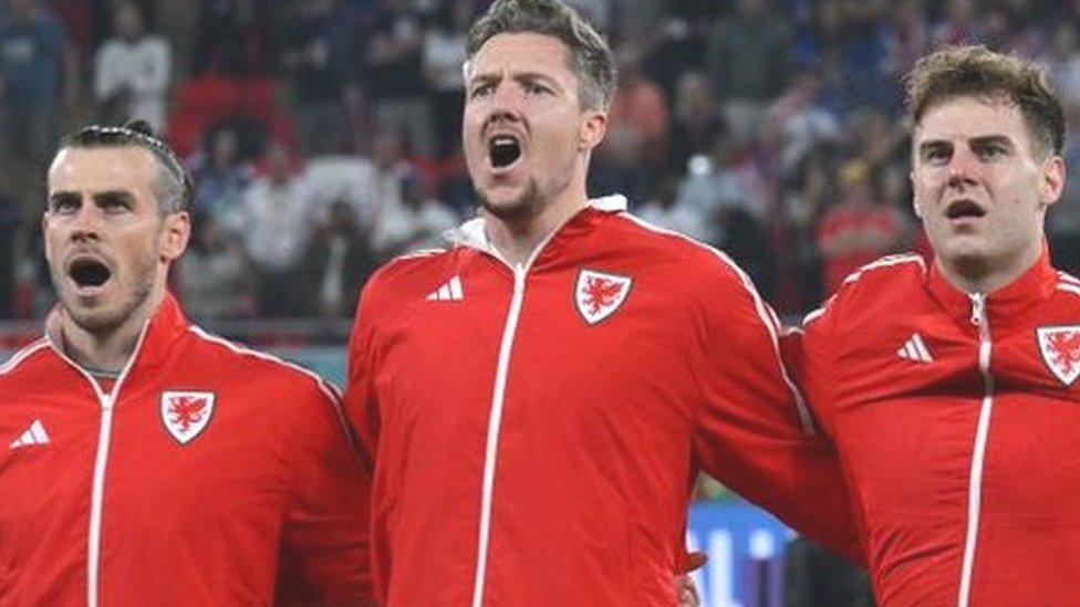 Left to toright: Wales' forward #11 Gareth Bale, Wales' goalkeeper #01 Wayne Hennessey, Wales' defender #06 Joe Rodon, Wales' defender #04 Ben Davies and Wales' defender #14 Connor Roberts sing their national anthem ahead of the Qatar 2022 World Cup Group B football match between USA and Wales at the Ahmad Bin Ali Stadium in Al-Rayyan, west of Doha on November 21, 2022